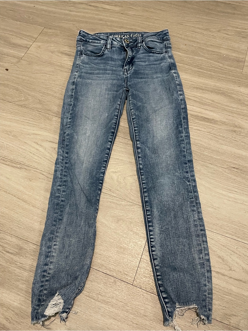 American Eagle Outfitters Women's Skinny Jeans - Faded Blue with Distressed Hem
